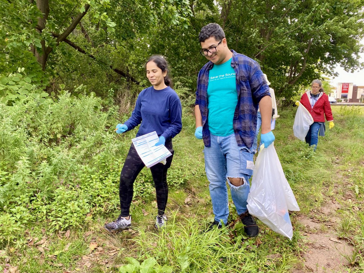 people carrying trash bags